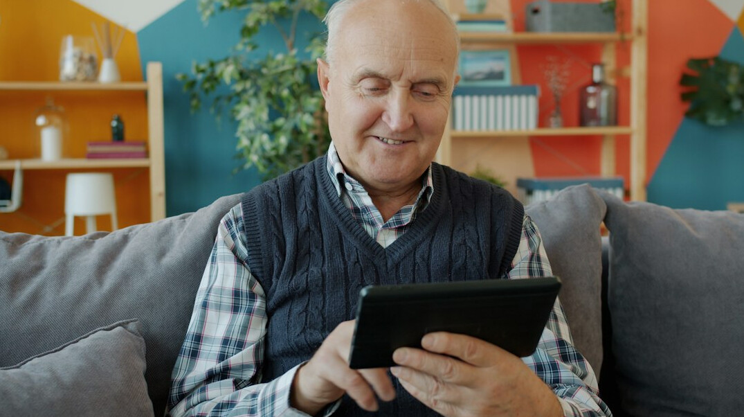 elderly person using tablet